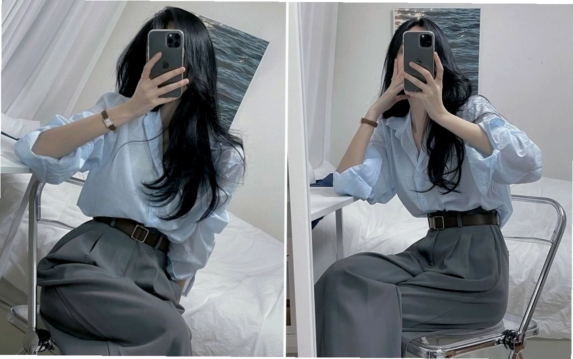 Cô gái xinh đẹp với mái tóc dài che một phần khuôn mặt khi chụp ảnh trước gương